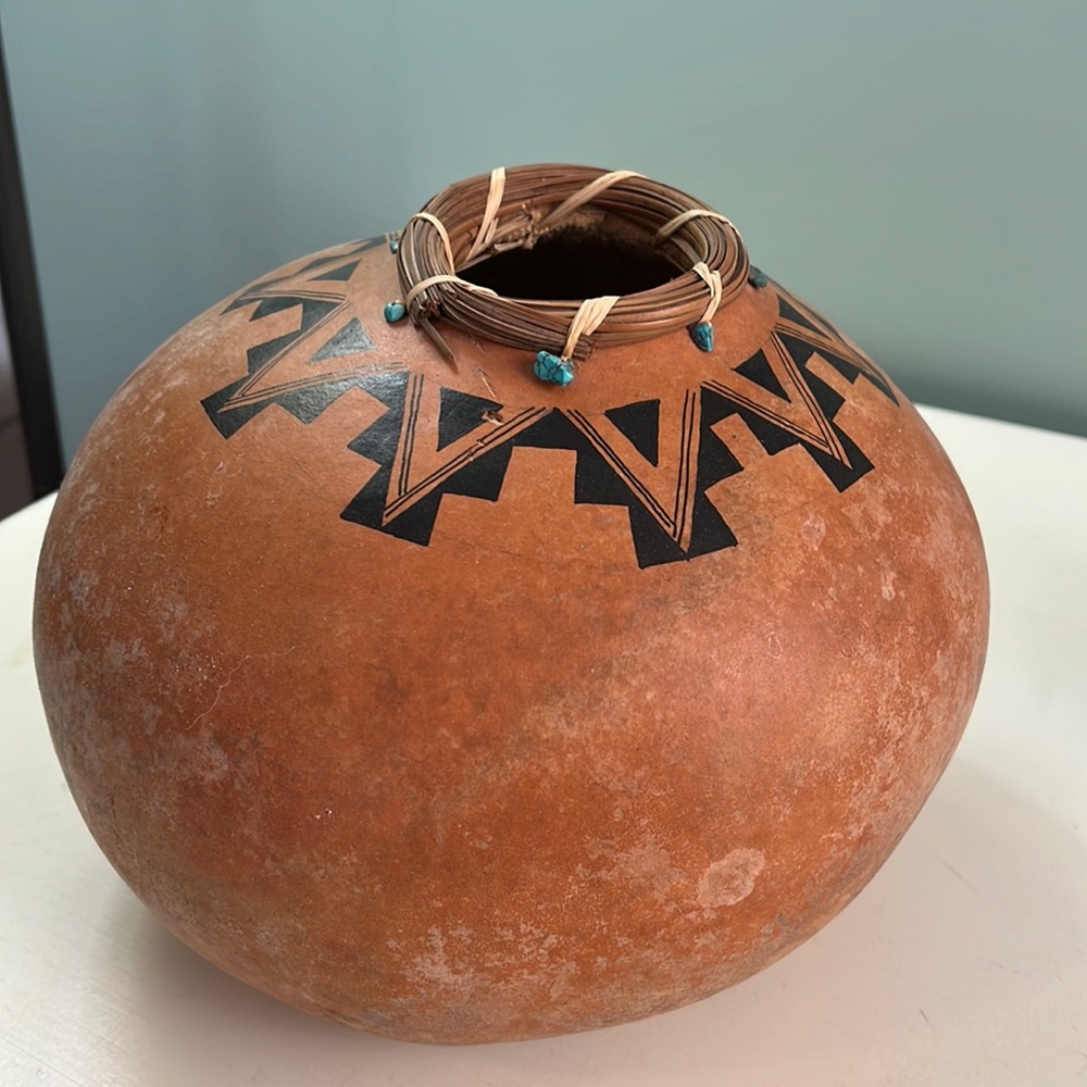 Native American painted gourd with turquoise pieces.